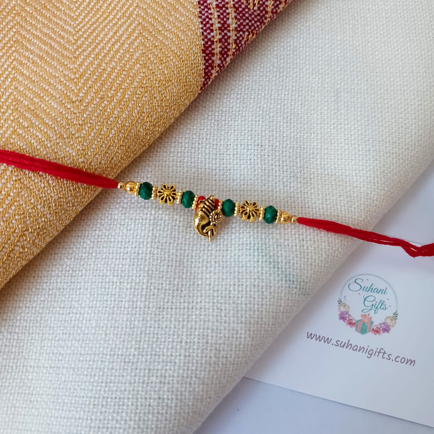 Floral Gold Rakhi On A Red Thread